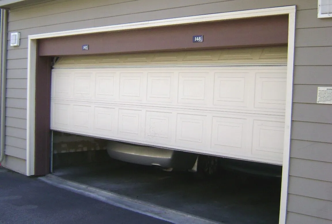 A white garage door halfway open