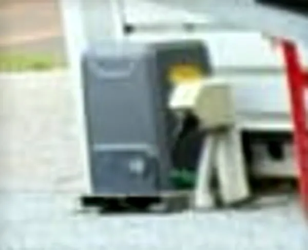 A grey Richmond GTR156 gate motor at ground level beside the gate